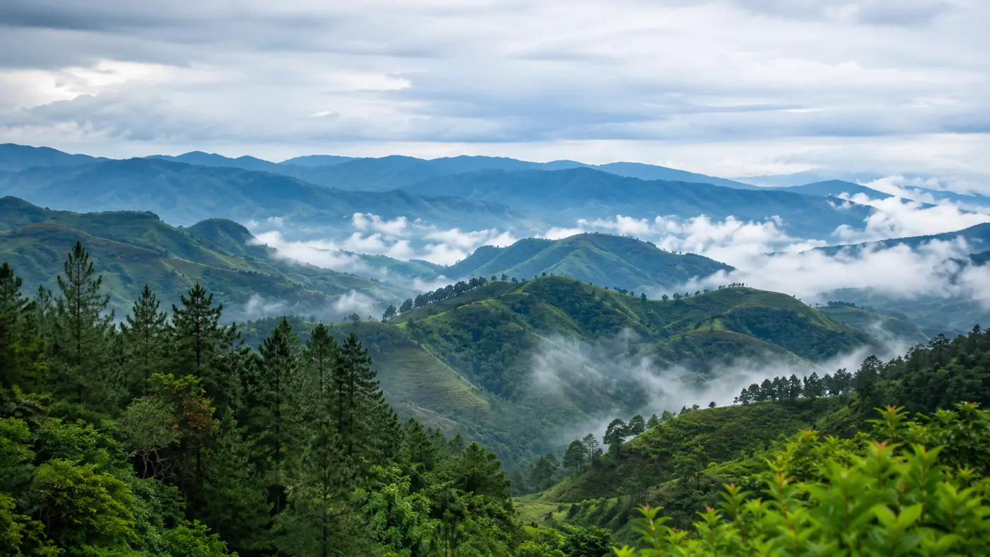 Mist drifting across layered Bukidnon mountain ridges