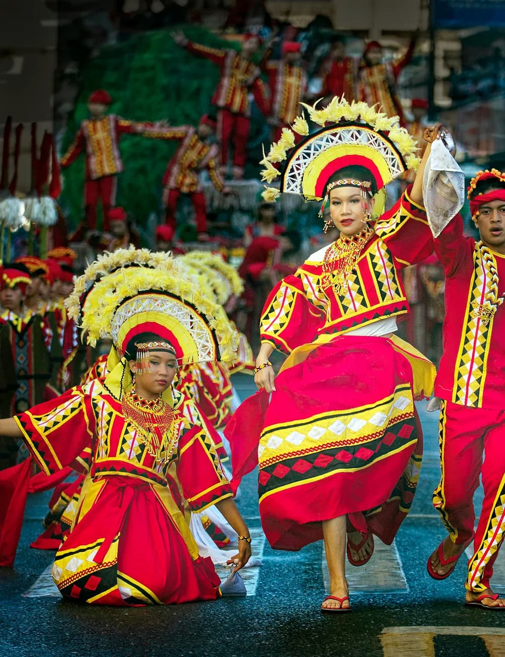 Kaamulan Festival dancers in tribal dress parading through Malaybalay